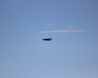 Coming in for a landing. The plane is on the downwind leg, parallel to the runway.